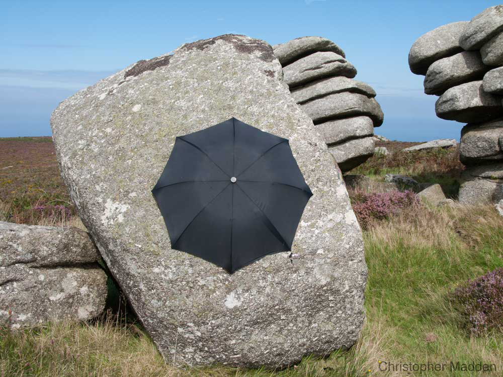 contemporary art in the environment - umbrella clinging to a rock, Cornwall