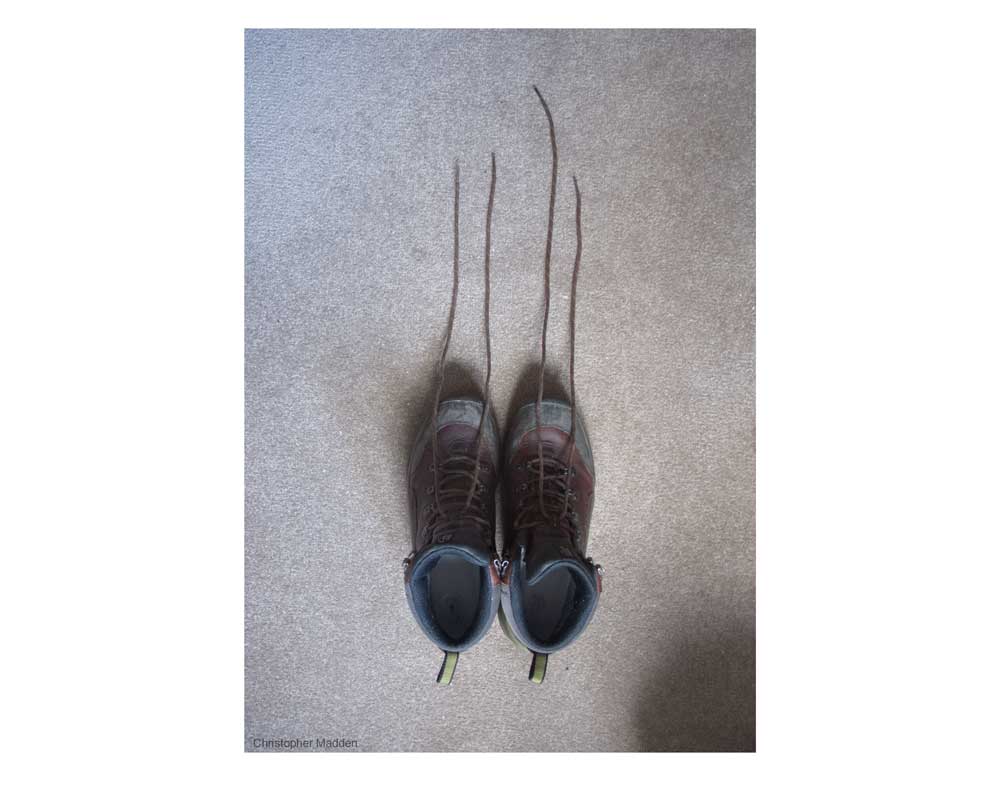 contemporary photography - shoes with laces extended - slightly unsettling contemporary photography - slightly sinister shoes