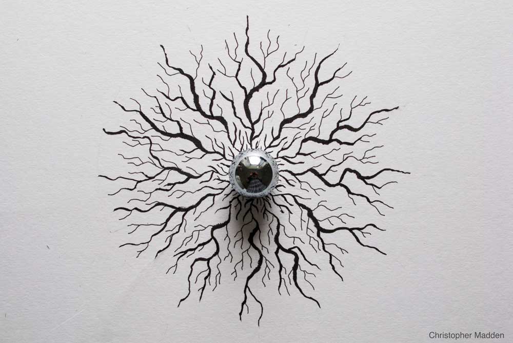 reflection in steel ball resembling eyeball steel sphere sculpture - reflections in a sphere