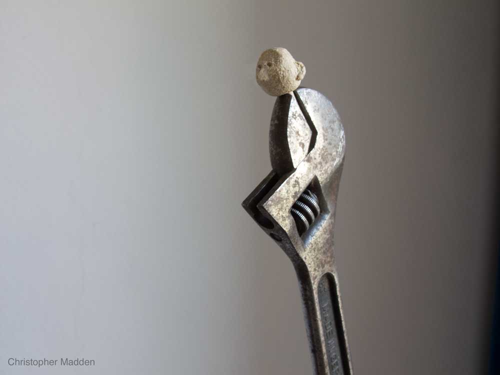 Sculpture - spanner with ceramic head attached Contemporary art sculpture featuring hand tools - spanner with a ceramic head
