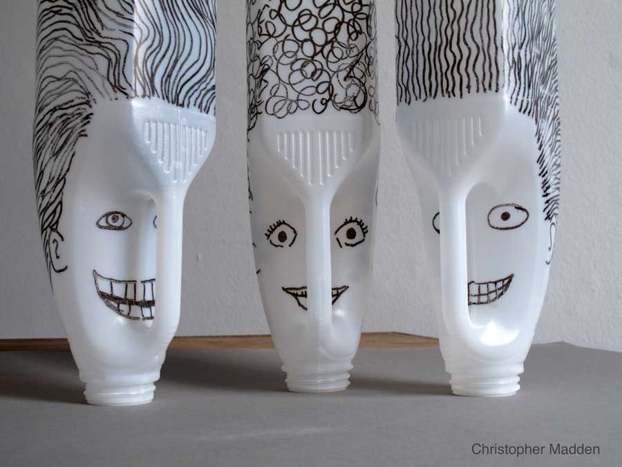 contemporary sculpture from plastic waste - sculptural heads created from plastic milk bottles contemporary environmental art sculpture created from consumer waste - heads created from plastic milk bottles