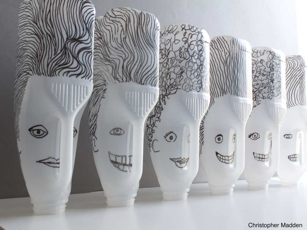Contemporary art - sculpture from recycled rubbish or junk - milk bottle heads