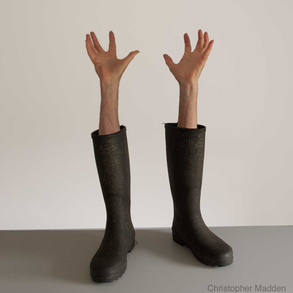 contemporary surrealist photomontage - wellington boots with arms emerging